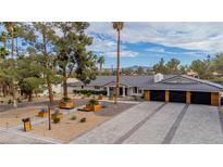 Stunning single-story home with an attached garage and a meticulously landscaped front yard at 3189 Montecito Dr, Las Vegas, NV 89120