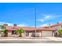 Charming single-story home featuring a tile roof, palm trees, and an attached two-car garage at 3434 Toquima Cir, Las Vegas, NV 89120