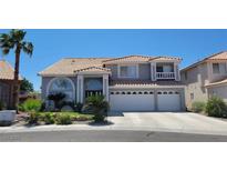 Charming two-story home featuring a three-car garage, tile roof, and landscaped front yard at 3805 White Castle St, Las Vegas, NV 89129