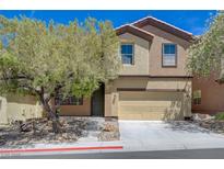 Inviting two-story home featuring neutral stucco, a two car garage, and a manicured front yard at 484 Merseyside Dr, Las Vegas, NV 89178