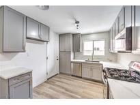 Modern kitchen features grey cabinets, stainless steel appliances, and white countertops for a contemporary look at 516 Donner St, Las Vegas, NV 89107