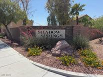 The Shadow Springs neighborhood sign sits proudly in a well-manicured stone-covered garden at 6141 Annville Ct, North Las Vegas, NV 89081