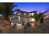 Inviting two-story home featuring desert landscaping, palm trees and a two-car garage at 6141 Annville Ct, North Las Vegas, NV 89081