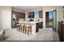 Charming kitchen boasts stainless steel appliances, dark wood cabinetry, and an island with bar stool seating at 627 Bellus Pl # Lot 156, Henderson, NV 89015