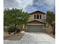 Charming two-story home featuring desert landscaping, a two-car garage, and inviting curb appeal at 6449 Lake Scene St, Las Vegas, NV 89148