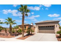 Attractive single-story home with a two-car garage and mature desert landscaping at 8536 Grand Palms Cir, Las Vegas, NV 89131