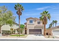 Charming two-story home with a well-maintained front yard and desert landscaping and tall palm trees at 8904 Meisenheimer Ave, Las Vegas, NV 89143