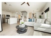 Bright living room featuring modern decor, sleek floors and an open floor plan to the kitchen at 10010 Aspen Rose St # 102, Las Vegas, NV 89183