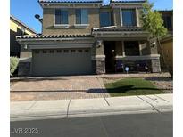 Two-story home featuring a two-car garage, covered entryway, and well-maintained landscaping at 109 Delighted Ave, North Las Vegas, NV 89031