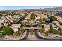 Beautiful Primary-planned community featuring well-manicured lawns, pool, and lush green landscaping at 1185 Via Dimartini, Henderson, NV 89052