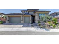 Charming single-story home featuring a three-car garage, beautiful landscaping, and a welcoming entrance at 12318 Tudor Arch Dr, Las Vegas, NV 89138