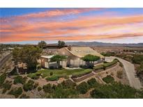 Expansive home with desert landscaping, and a beautiful sunset backdrop for peaceful living at 1409 Pueblo Dr, Boulder City, NV 89005