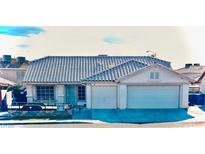 Charming single-story home featuring a tile roof, two-car garage, and well-maintained front yard at 1619 Tangerine Rose Dr, Las Vegas, NV 89142