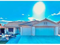 Bright, sun-drenched single-story home with a well-maintained front yard and two-car garage at 1619 Tangerine Rose Dr, Las Vegas, NV 89142