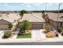 Inviting single-story home with a well-manicured front yard and a two-car garage in a desirable neighborhood at 2021 Pelican Sky Beach Ave, North Las Vegas, NV 89081