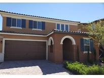 Charming two-story home showcasing its appealing exterior with attached garage and arched entryway at 2580 Sable Ridge St, Henderson, NV 89044