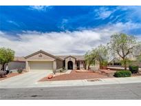 Charming single-story home with desert landscaping, beautiful trees, and a two-car garage at 2804 Sapphire Desert Dr, Henderson, NV 89052