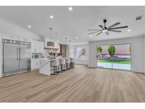 Bright kitchen with a waterfall island, stainless steel appliances, and seamless access to outdoor living at 3109 Siena Cir, Las Vegas, NV 89128