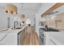 Modern kitchen features quartz countertops, stainless steel appliances, and stylish lighting at 3109 Siena Cir, Las Vegas, NV 89128