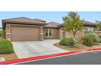 Charming single-story home with a two-car garage, desert landscaping, and a red concrete curb at 3805 Specula Wing Dr, North Las Vegas, NV 89084