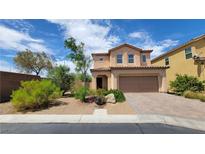 Charming two-story home featuring a well-manicured front yard with stone and desert landscaping at 386 Botanic Gardens Dr, Las Vegas, NV 89148
