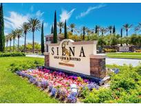 Welcoming entrance to Siena Golf Club & Bistro with colorful flower beds and lush landscaping at 4208 Agosta Luna Pl, Las Vegas, NV 89135
