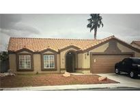 Charming single-story home featuring a tile roof, two bay windows, a welcoming entrance, and a convenient two-car garage at 5020 Wildroot Rd, Las Vegas, NV 89130