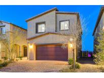 Two-story home with a two car garage and a desert landscape with a brick paver driveway at 5236 Sunstone Mesa Dr, Las Vegas, NV 89166