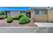 Two-story home featuring desert landscaping, a two-car garage and a quaint balcony area at 532 Greenbriar Pl, Boulder City, NV 89005