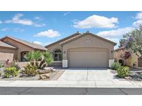 Charming single-story home featuring a well-manicured yard with desert landscaping and an attached two-car garage at 6039 Tokara Ave, Las Vegas, NV 89122