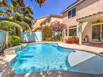 Sparkling pool with lush landscaping and beautiful views in a serene backyard setting at 6779 Goose Watch Ct, Las Vegas, NV 89139