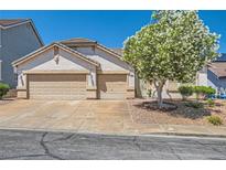 Charming single-story home features a two-car garage and a well-maintained front yard with mature landscaping at 89 Autumn Day St, Henderson, NV 89012