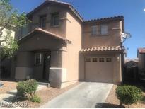 Two-story house with a well-maintained front yard and attached garage at 8982 Leaping Pad Ct, Las Vegas, NV 89148