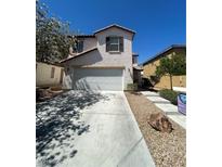 Charming two-story home with a well-maintained front yard, concrete driveway, and a two-car garage at 9082 Amanda Creek Ct, Las Vegas, NV 89149