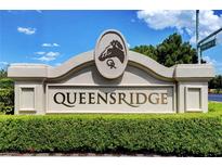 Elegant community signage features the Queensridge neighborhood with lush green landscaping at 9704 Royal Lamb Dr, Las Vegas, NV 89145