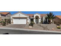 Charming single-story home featuring a well-maintained lawn and a two-car garage at 10100 Folsom Dr, Las Vegas, NV 89134