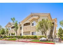 Charming condo building featuring a tan facade, well-maintained landscaping, and convenient stair access at 10109 Jacob Pl # 203, Las Vegas, NV 89144