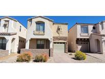 Charming two-story townhome featuring desert landscaping and an attached one car garage at 10230 Viterbo St, Las Vegas, NV 89183