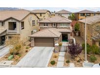 Beautiful two story home with desert landscaping, 2-car garage, and decorative stone accents on the facade at 10440 Bay Ginger Ln, Las Vegas, NV 89135
