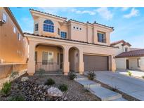 Charming two-story home features a covered porch, desert landscaping, and an attached two-car garage at 10458 Gabaldon St, Las Vegas, NV 89141