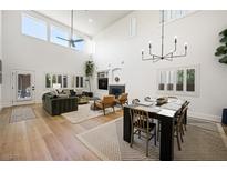 Bright and airy living space with high ceilings, modern chandelier, and comfortable seating arrangement at 11340 Espadrille Ct, Las Vegas, NV 89138