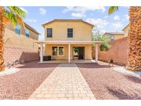 Well maintained backyard featuring pavers, a covered patio, and privacy wall at 11755 Garland Grove Ln, Las Vegas, NV 89183