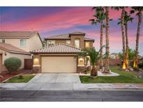 Charming two-story home with a well-maintained front yard and a two-car garage under a beautiful pink and purple sky at 1200 Dream Bridge Dr, Las Vegas, NV 89144