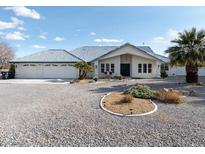 Well-maintained home featuring desert landscaping, a three-car garage, and charming curb appeal at 1251 Cavalry St, Pahrump, NV 89048
