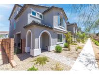 Charming two-story home features a welcoming arched entryway and low-maintenance desert landscaping at 1323 Cerulean Ave, Henderson, NV 89002