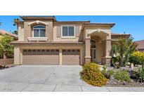 Charming two-story home features a welcoming entrance, well-manicured landscaping, and a convenient two-car garage at 2329 Sunrise Meadows Dr, Las Vegas, NV 89134