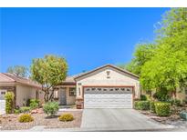 Charming single-story home with a well-manicured front yard and a two-car garage at 2550 Evening Twilight Ave, Henderson, NV 89044