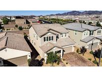 Beautiful two-story home featuring a neutral color palette, desert landscaping, and a tile roof at 2628 Ferrara St, Henderson, NV 89044