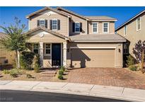 Charming two-story home boasts a well-maintained lawn, a brick driveway, and an attached two-car garage at 2628 Ferrara St, Henderson, NV 89044