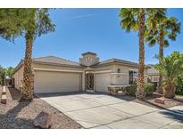 Charming single-story home with desert landscaping, palm trees and a spacious three-car garage at 2668 Ivoryhill St, Las Vegas, NV 89135